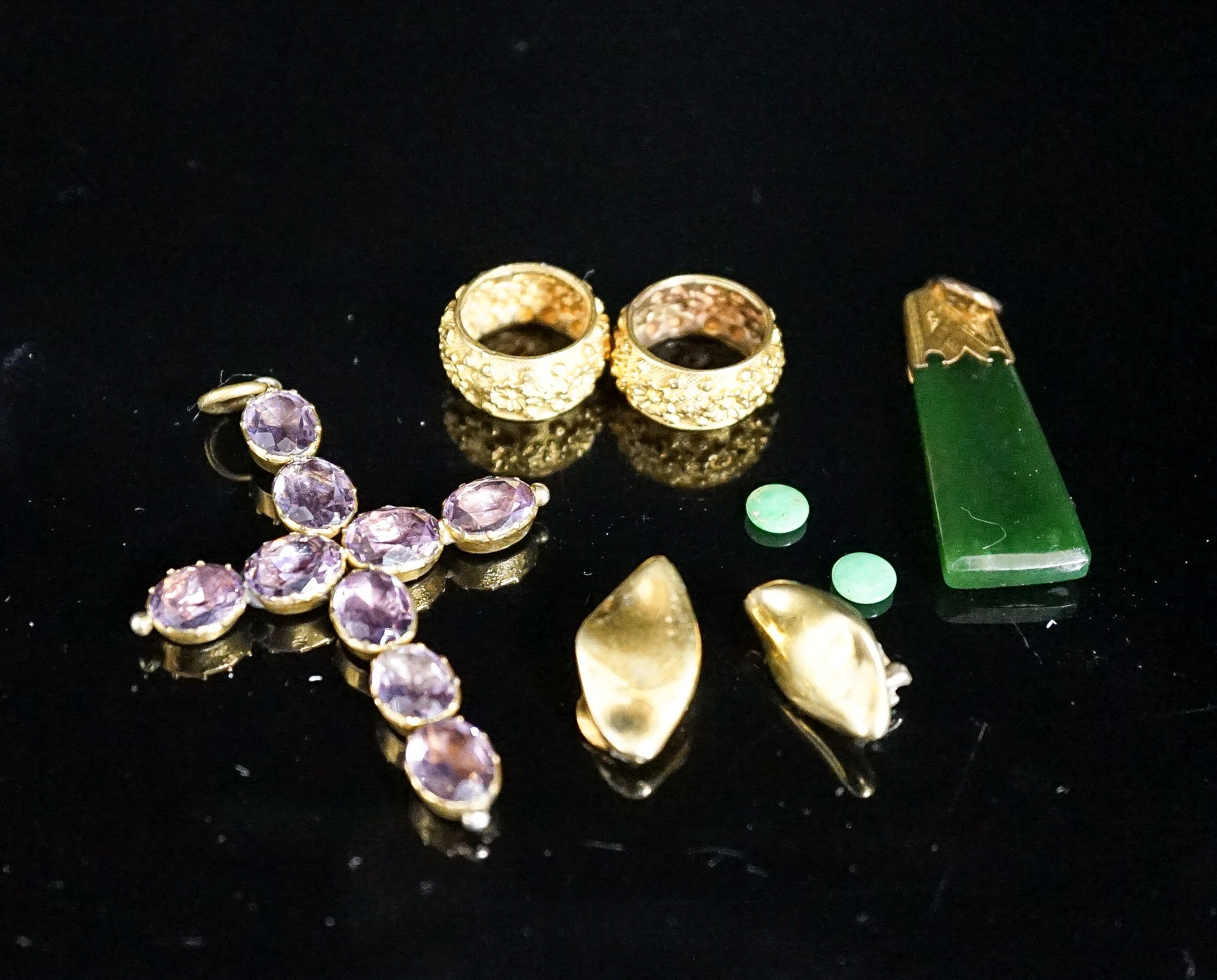 A Victorian gilt metal and foil backed amethyst paste set cross pendant, 67mm, a yellow metal mounted jade pendant and five other items.